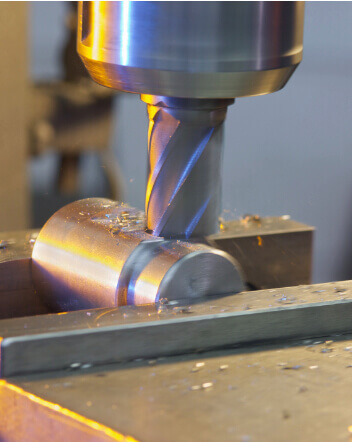 Close-up of a milling machine cutting into metal.